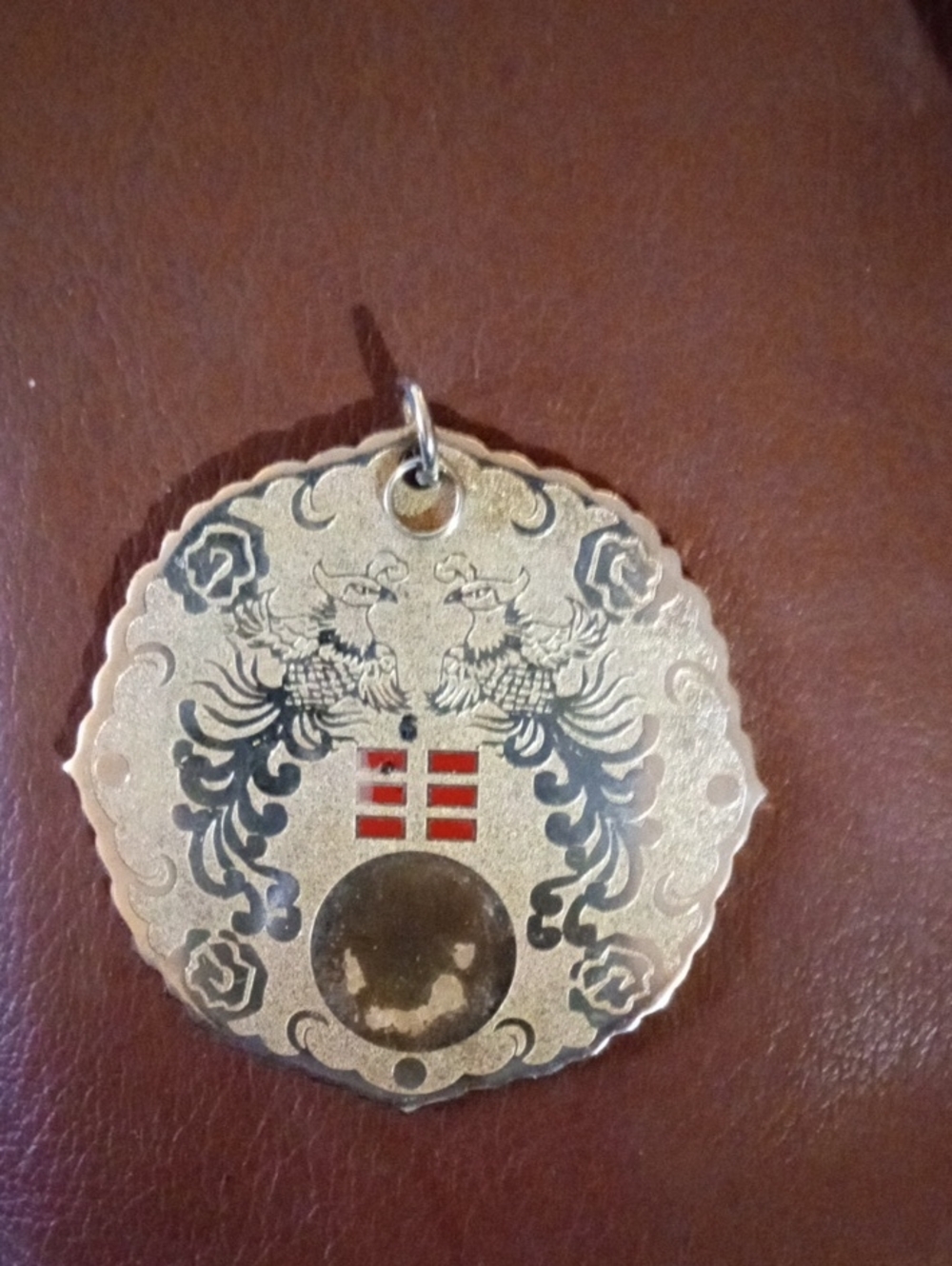 Decorative Gold-tone Medallion Pendant with Red and Black Accents